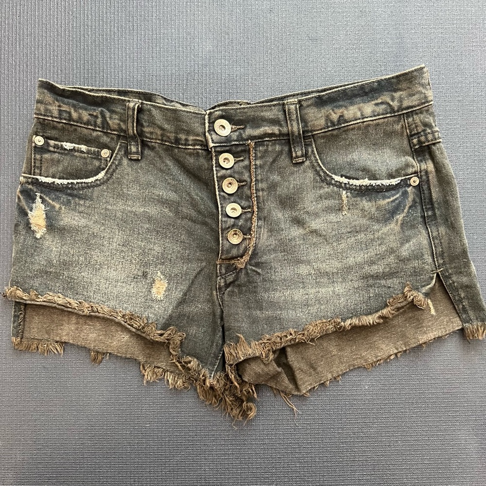 Free People distressed black button fly shorts.